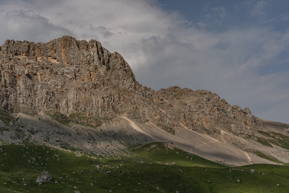 a very tall mountain with a sky in the background