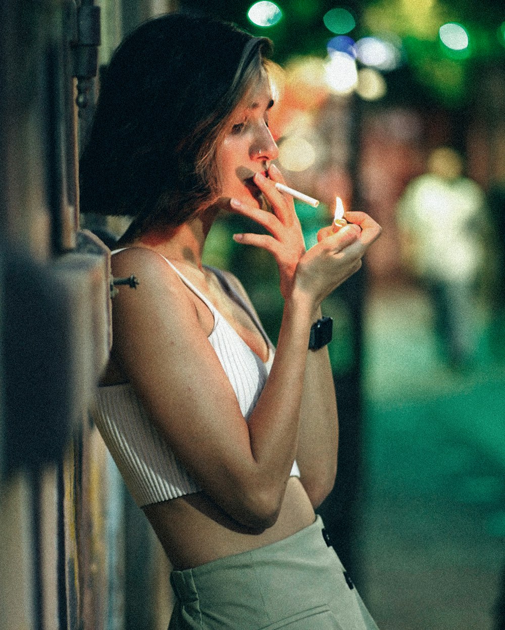 a woman smoking a cigarette on a city street