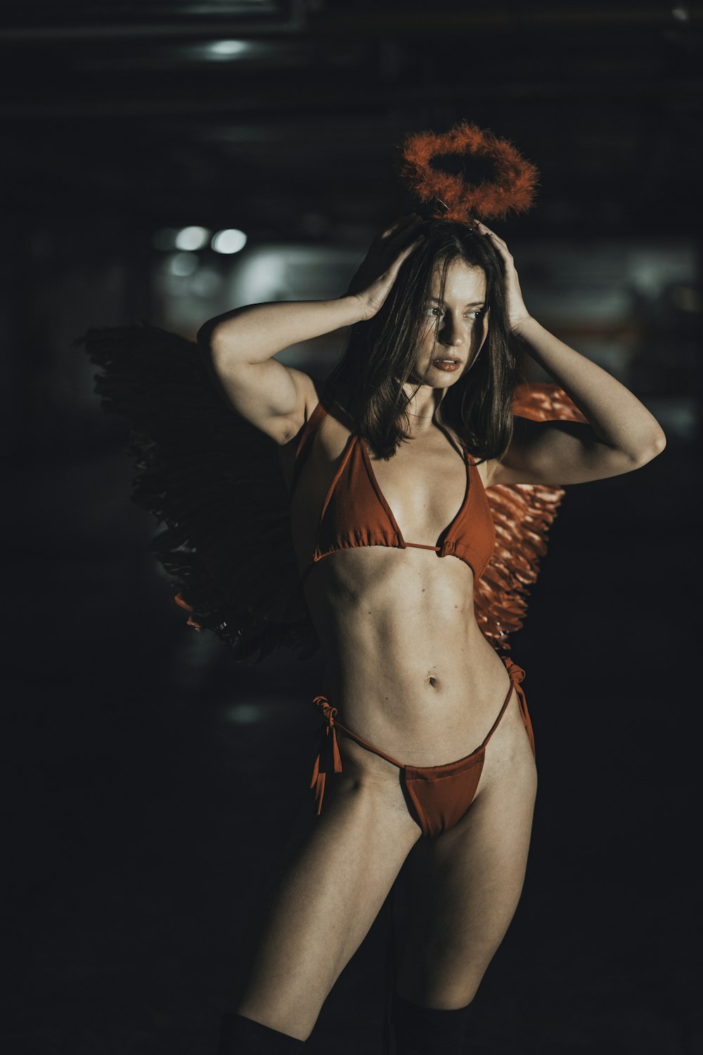 a woman in a bikini with wings on her head