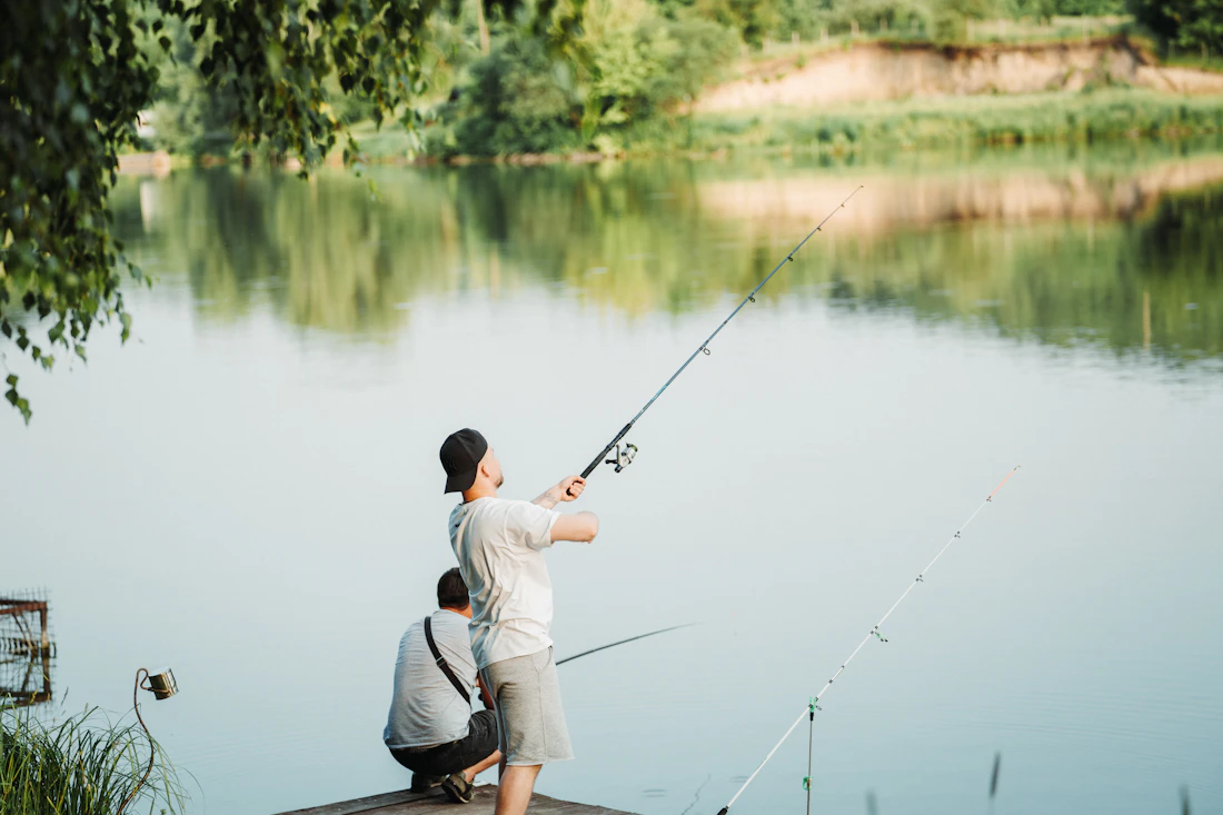 Adult and child fishing from a dock