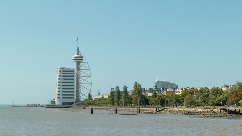 a large body of water with a tall building in the background