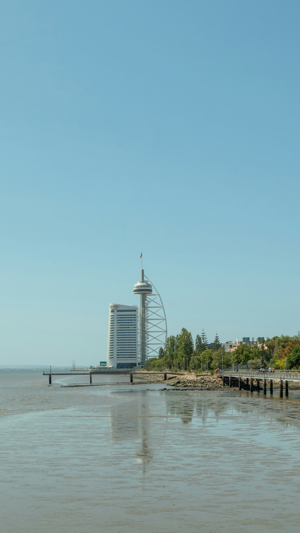 a view of the ocean with a roller coaster in the background