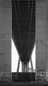 a black and white photo of the underside of a bridge