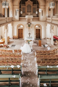 A couple exchanging wedding vows in the beautifully decorated church altar.