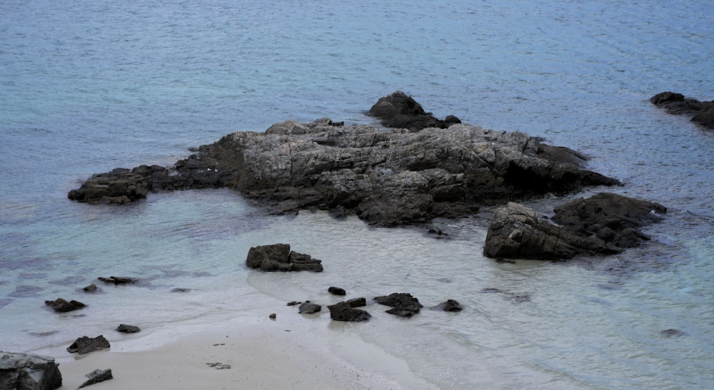 a beach with rocks and water on it