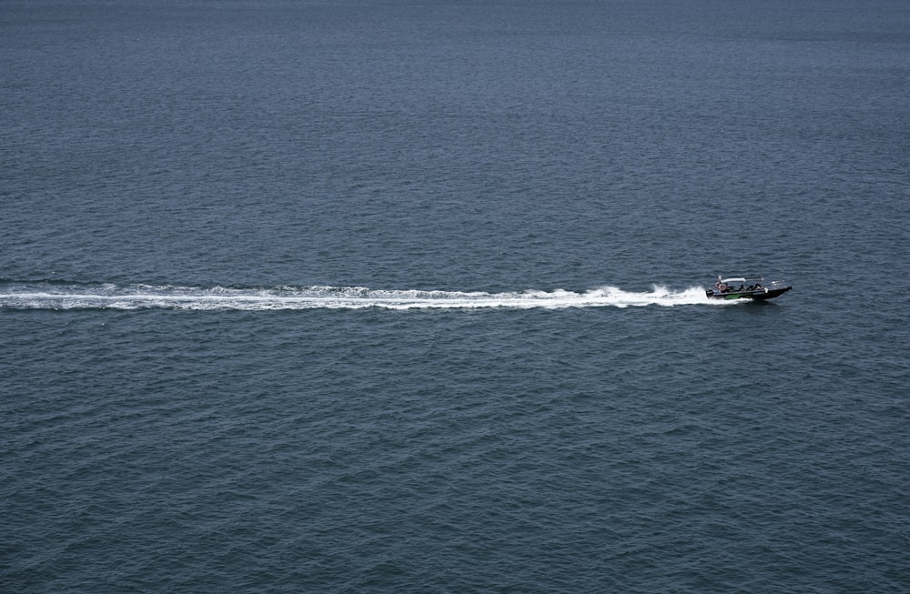 a small boat traveling across a large body of water