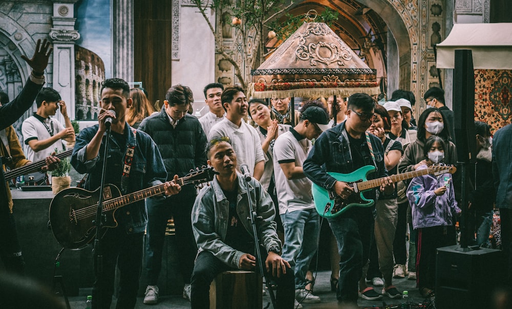 a group of people standing around with guitars