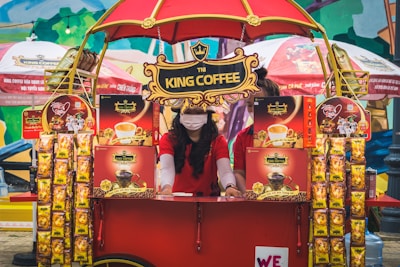 A vibrant pop-up setup at a local event with happy customers enjoying coffee.