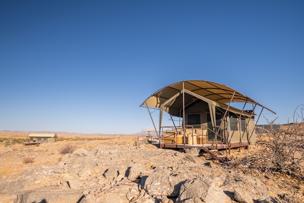 a small house sitting on top of a rocky hill