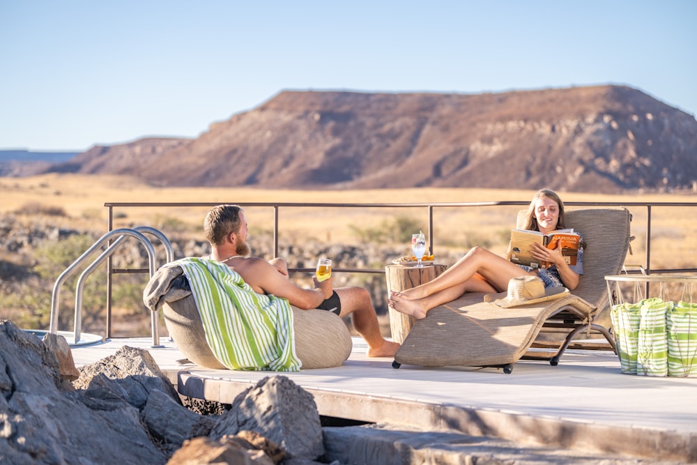 a man and a woman are sitting on a deck