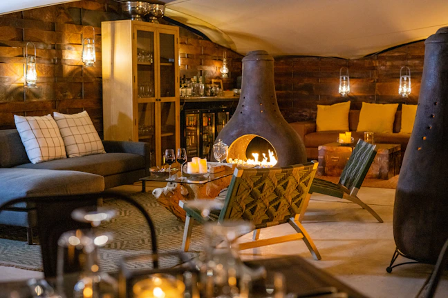 A cozy, artfully decorated lounge area for an intimate social gathering, mixing modern and rustic styles