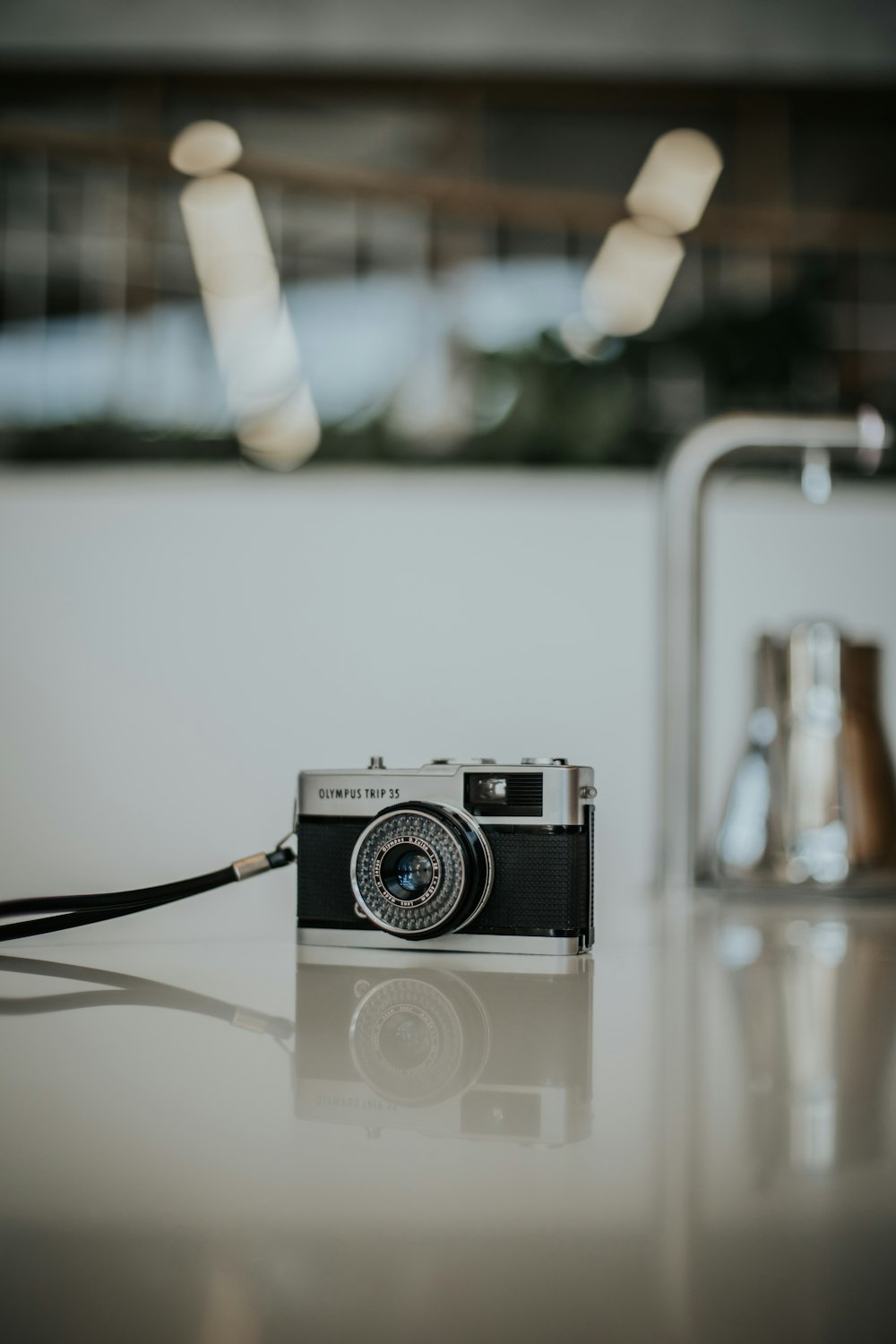 a camera sitting on top of a table next to a faucet