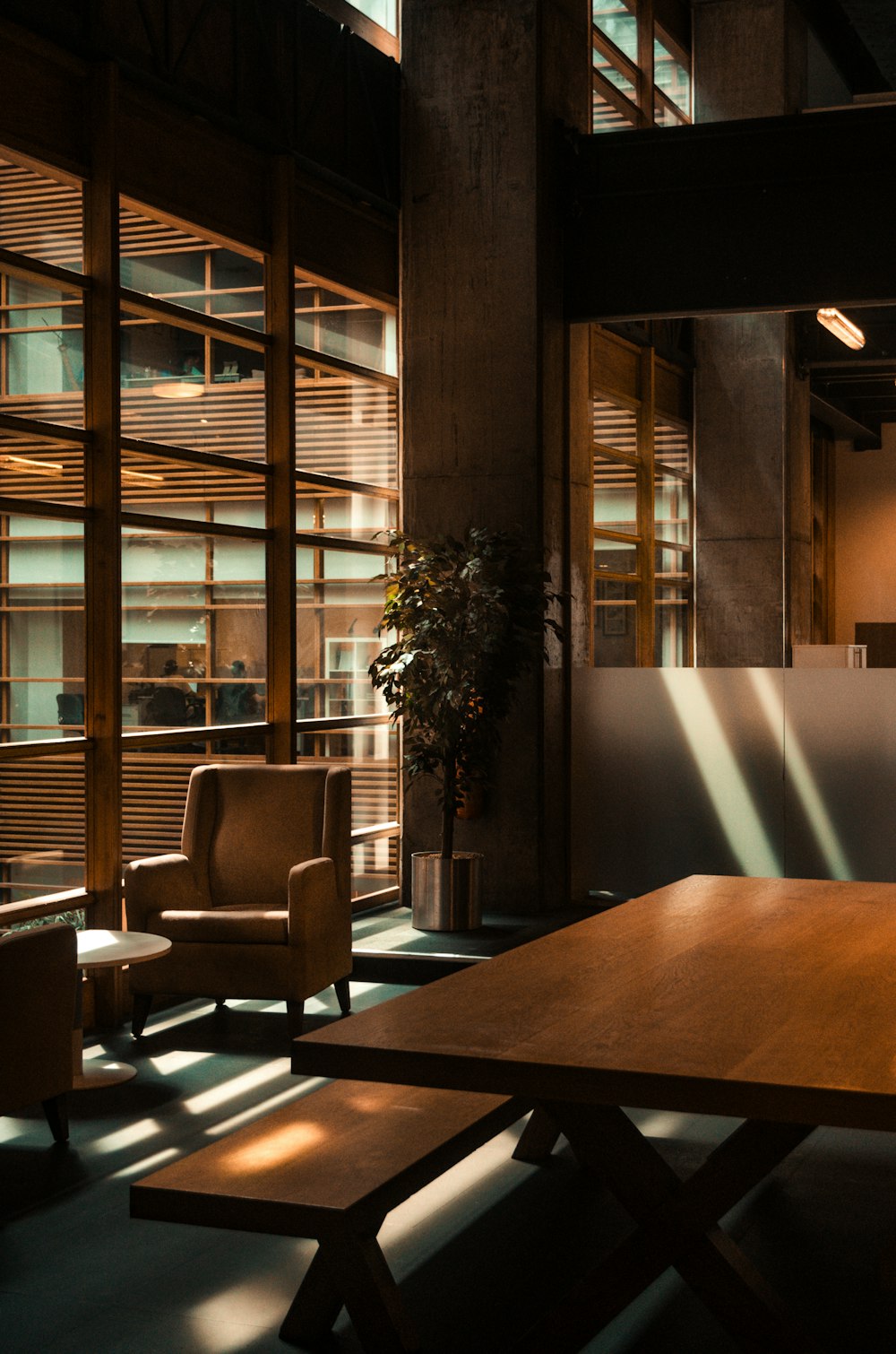 a wooden table sitting in a room next to two chairs