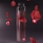 a glass vase filled with water and red petals