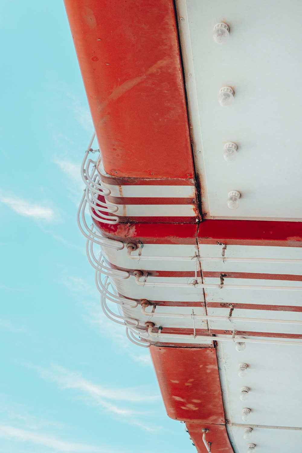 a close up of a red and white structure against a blue sky