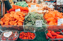 A vibrant market stall displaying fresh dried apricots, dates, and figs.