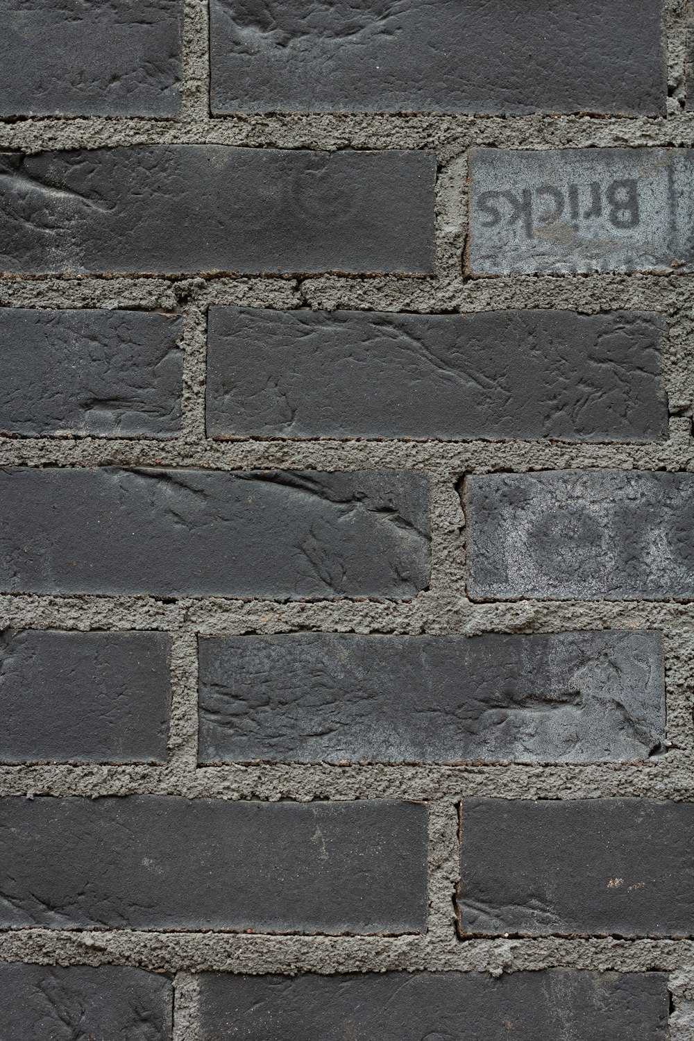 a close up of a brick wall with a sign on it