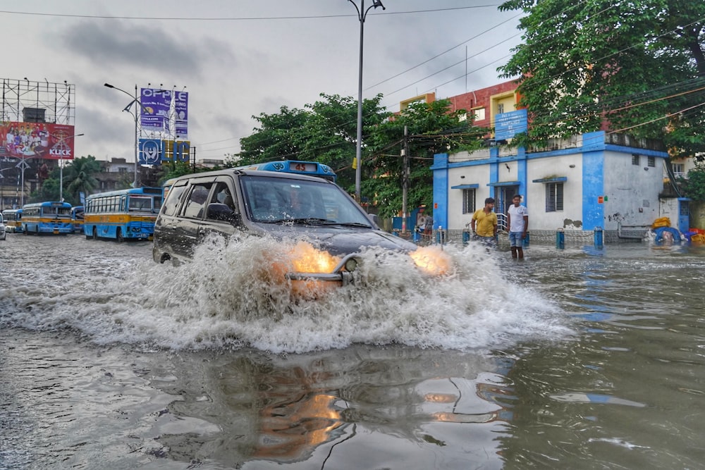 a car is driving through a flooded street