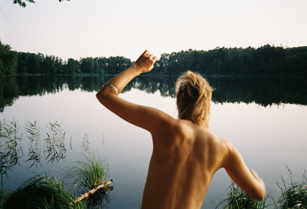 a man standing next to a body of water