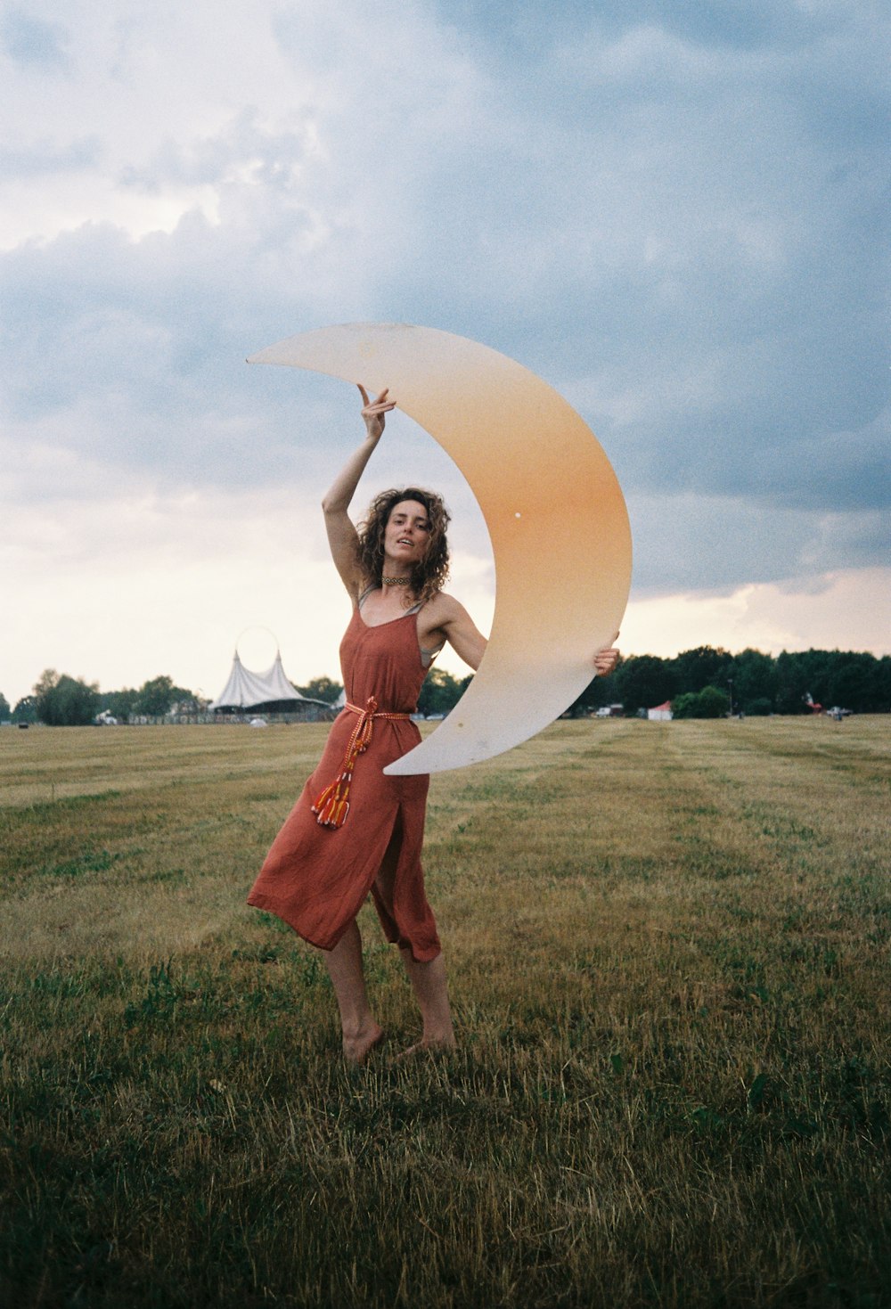 a woman in a red dress holding a white frisbee