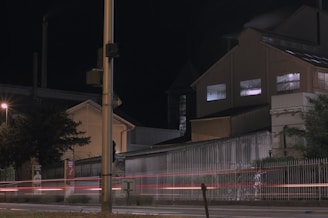 Evening shot of an industrial complex with exterior lights illuminating the building’s facade.