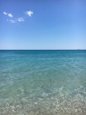 Relaxing beach scene at Pantai Utama Raya with clear blue water