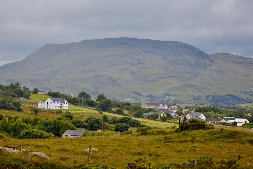 a house on a hill with a mountain in the background