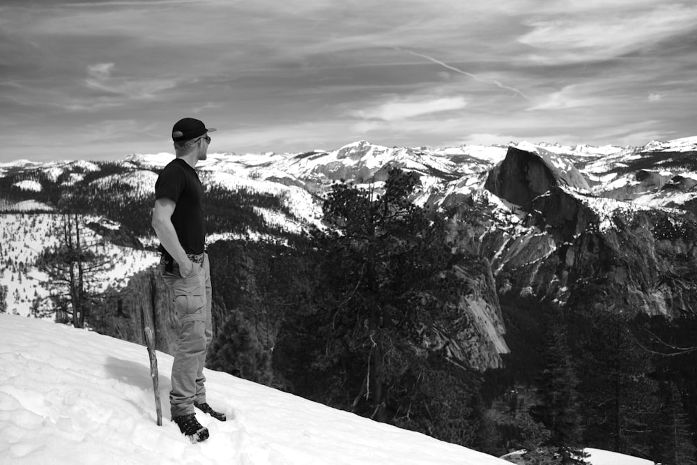 a man standing on top of a snow covered slope