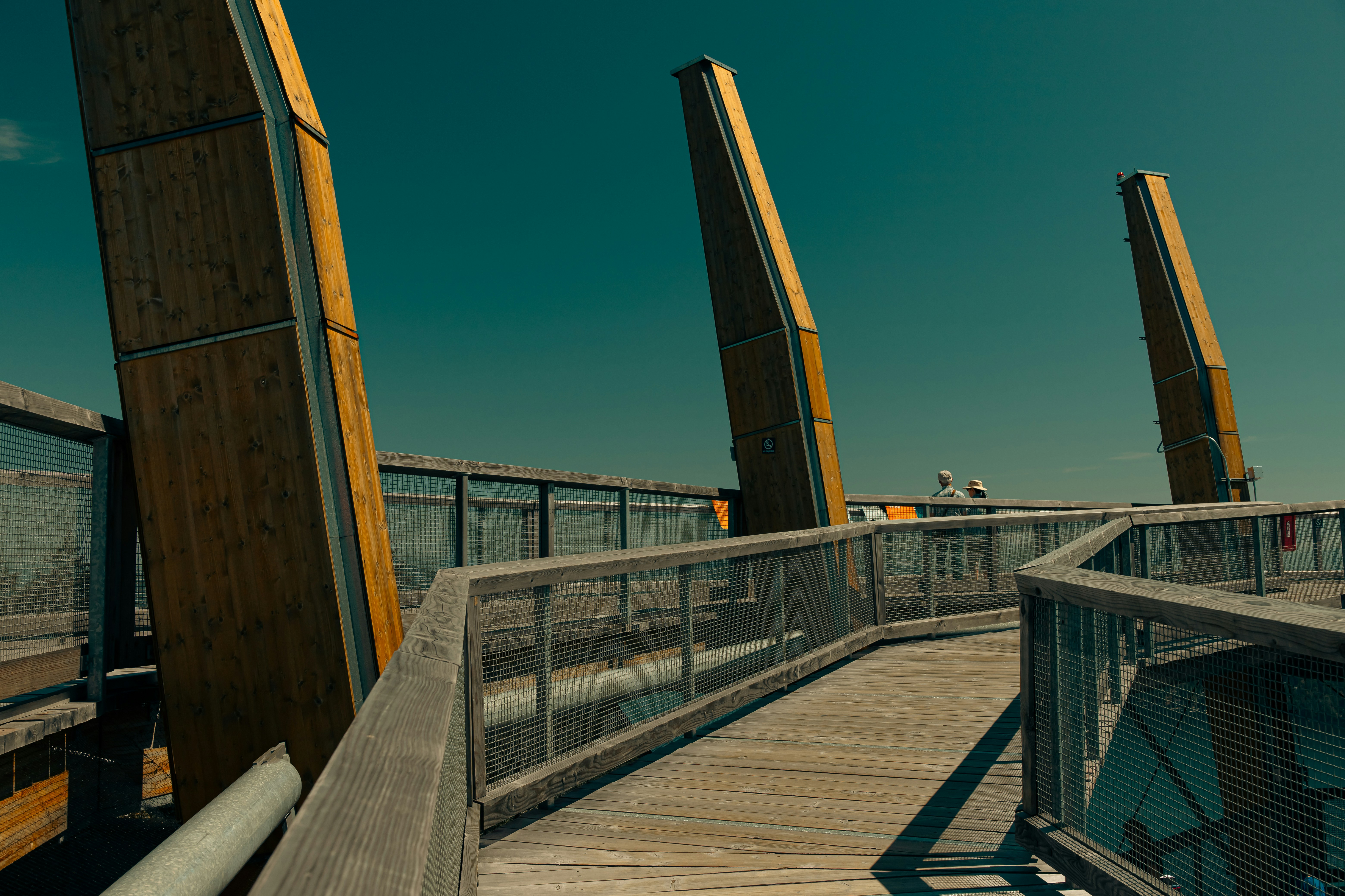  A close-up shot of a developer's hands typing commands into a computer terminal displaying various Docker commands like 'docker run' or 'docker build' and their output, set against a blurred background of a development environment.