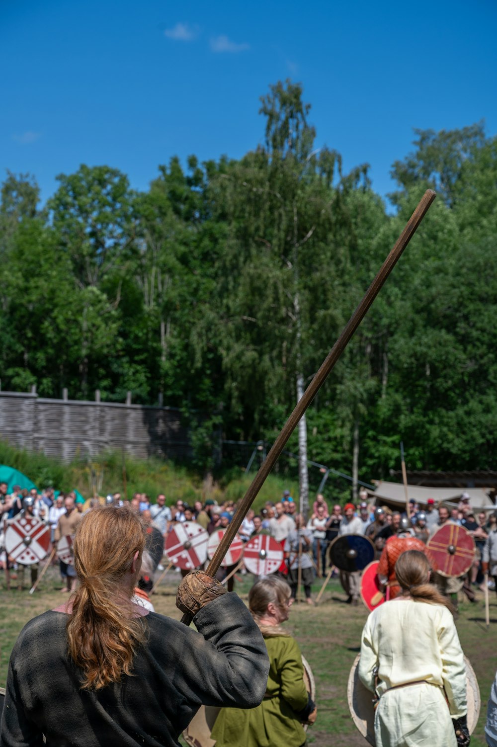 a group of people watching a man with a sword