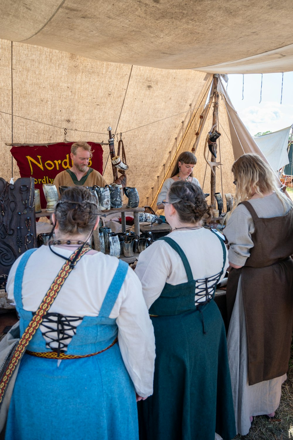 a group of people standing around a tent