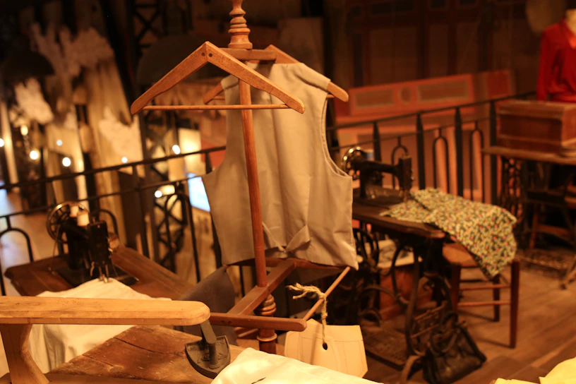 Cozy interior of atelier miuart showing sewing machines and fabric rolls.
