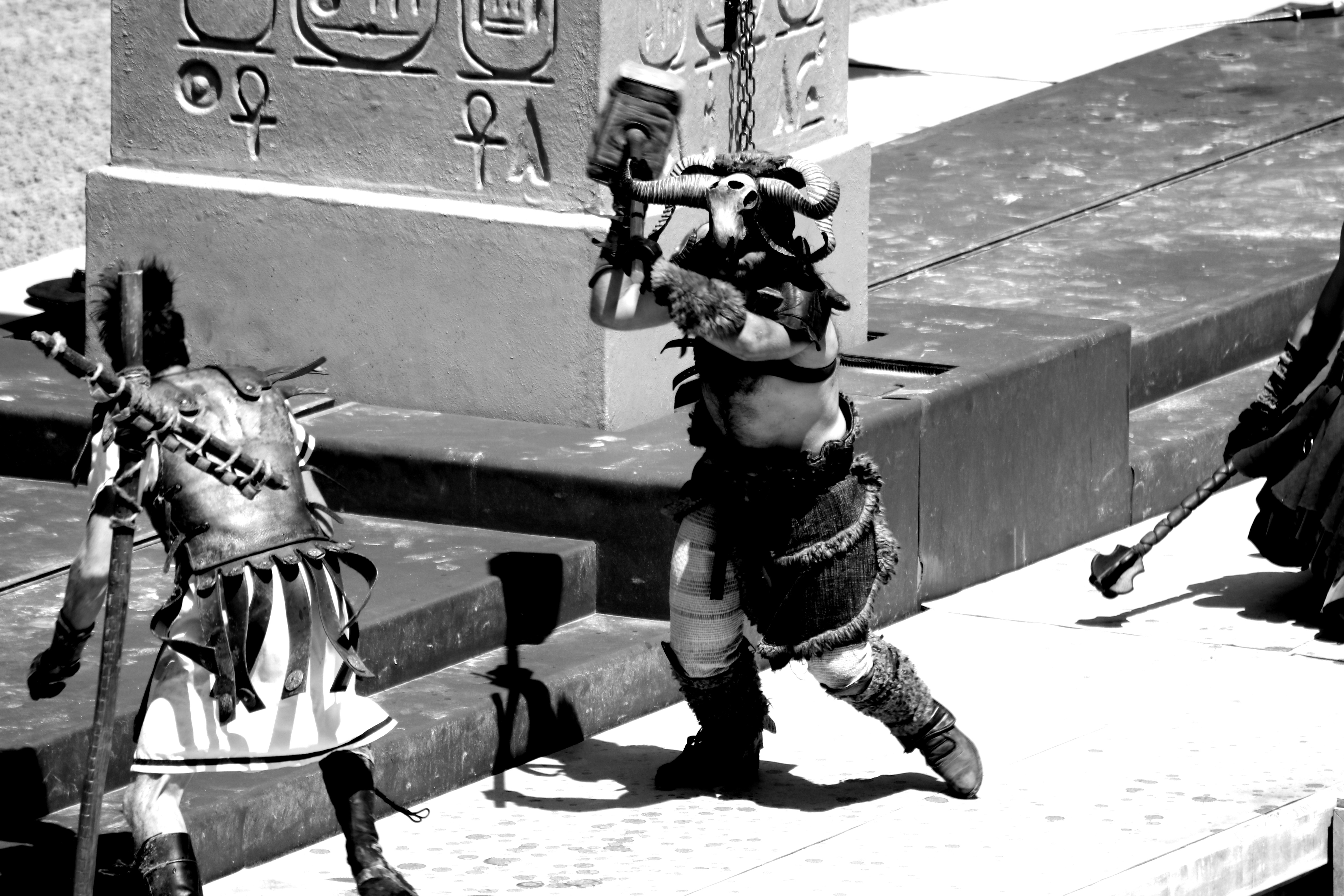 a black and white photo of a man in armor