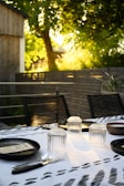 An inviting outdoor dining area set up for a private catering event at sunset.