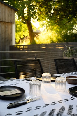 An inviting outdoor dining area set up for a private catering event at sunset.