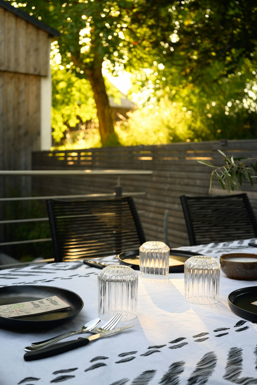 a table with a white table cloth and black plates