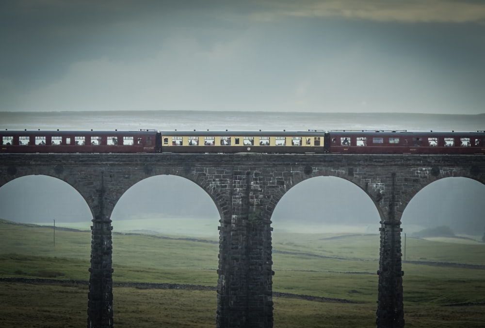 a train traveling over a bridge next to a body of water