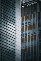 Photo of a modern residential building and a commercial property side by side.