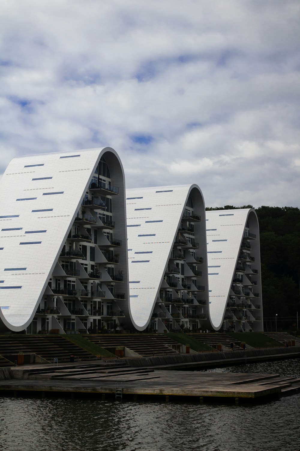 a large white building sitting next to a body of water