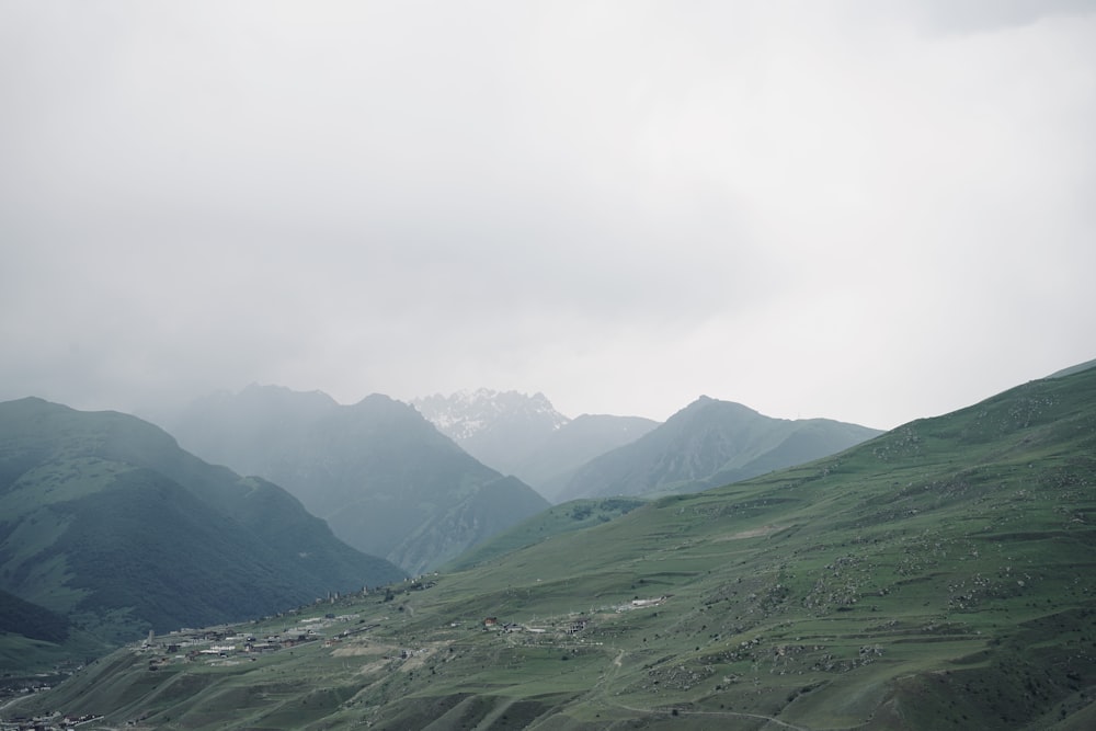 a view of a valley with mountains in the background