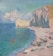 A coastal seascape depicting a tranquil beach with several small boats and colorful sails resting on the sand. Towering cliffs rise sharply at the right, while the crystal-clear blue-green sea stretches towards the horizon under a sky filled with soft, fluffy clouds.