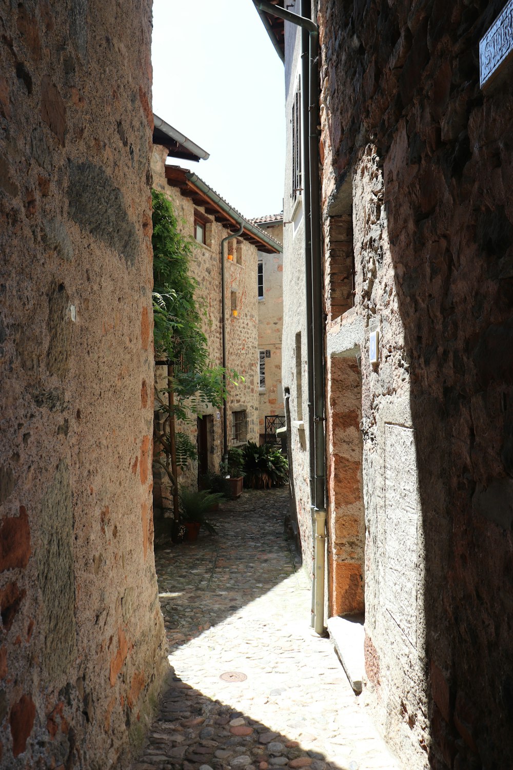 a narrow cobblestone street in a small village