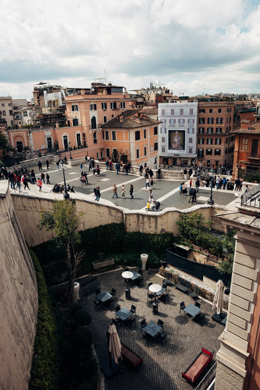 a group of people walking around a courtyard