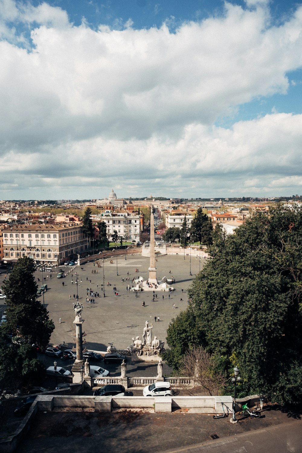 a view of a square with a statue in the middle