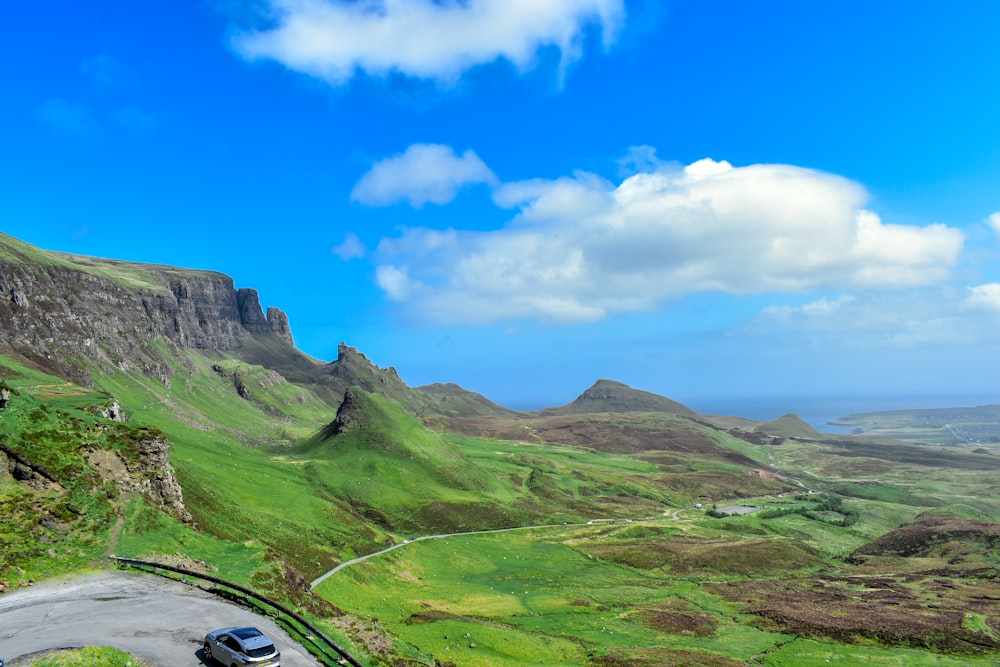 a car driving down a winding road in the mountains