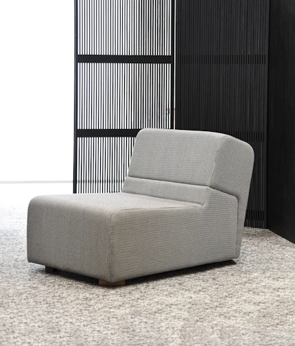 A sleek, modern armchair with clean lines and light gray fabric, perfect for contemporary spaces.