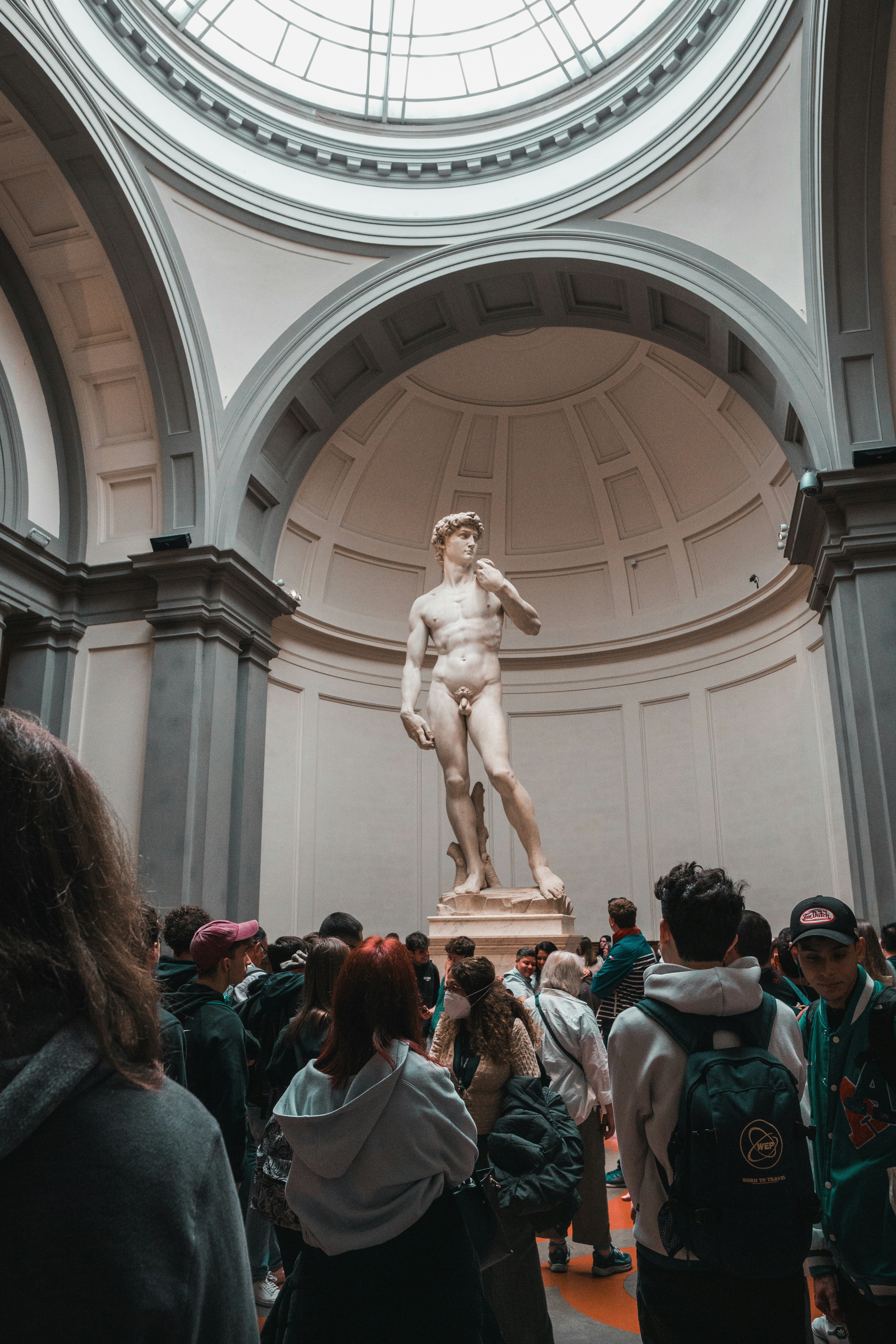 a group of people standing around a statue