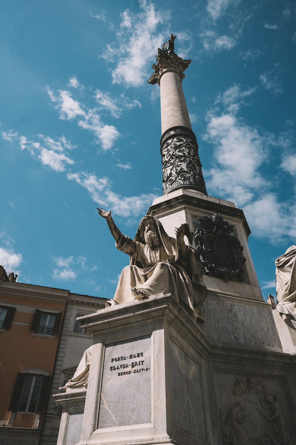 a statue of a woman pointing at the sky