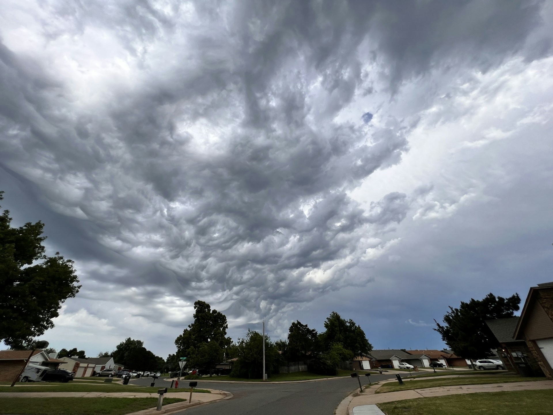 woman wearing yellow long-sleeved dress under white clouds and blue sky during daytime