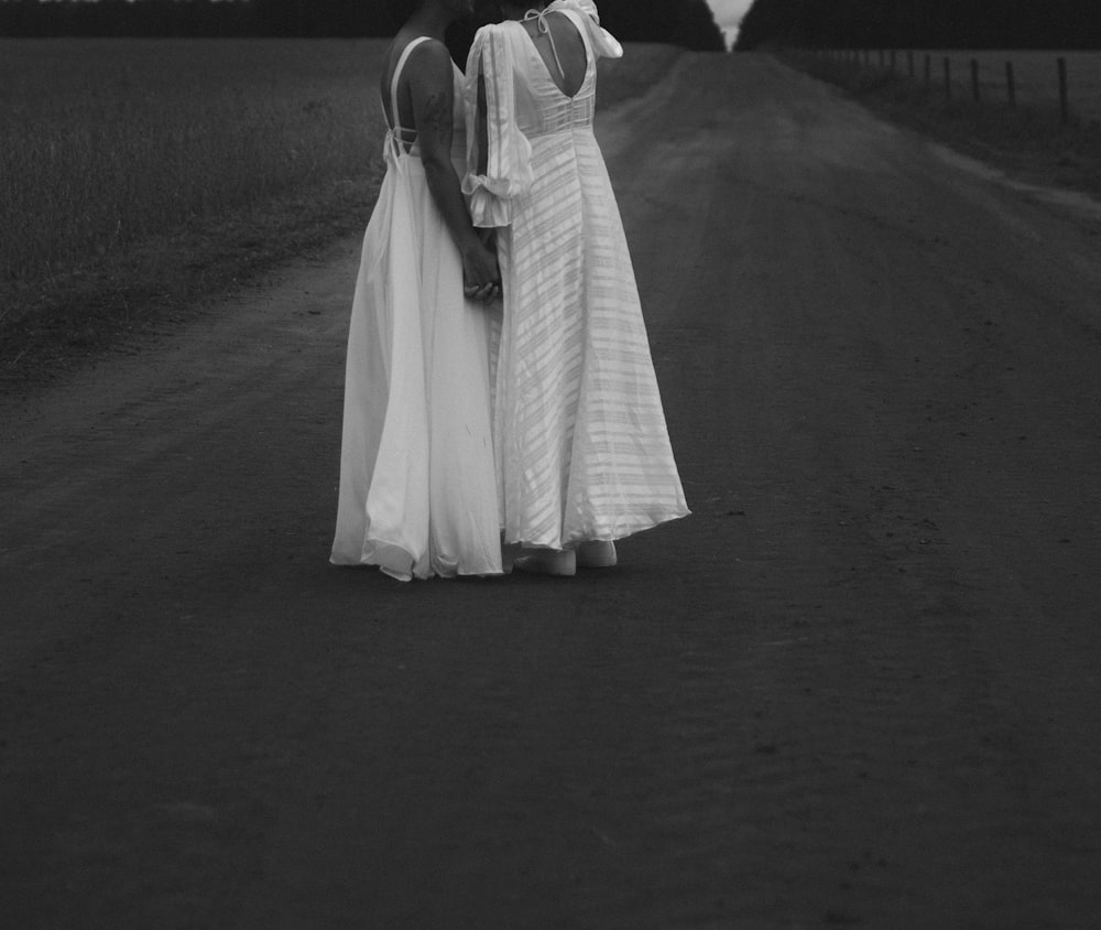 a woman in a white dress holding an umbrella